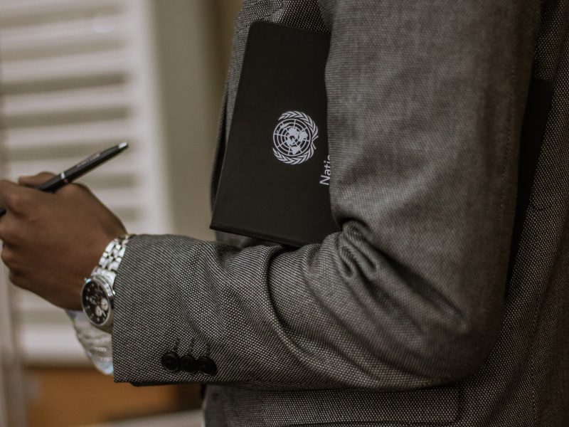 Man holding a UN folder under his arm